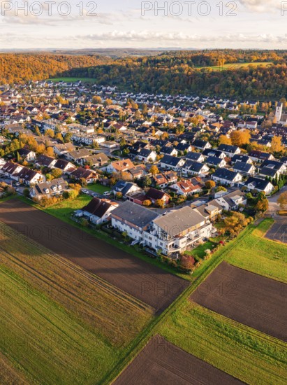 Aerial view of a village with adjacent fields surrounded by autumn colors, Aidlingen, Böblingen district, Germany