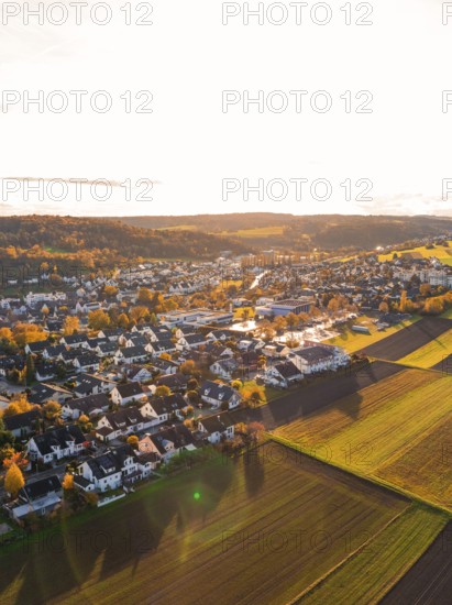 A village in warm autumn light with surrounding fields, Aidlingen, Böblingen district, Germany