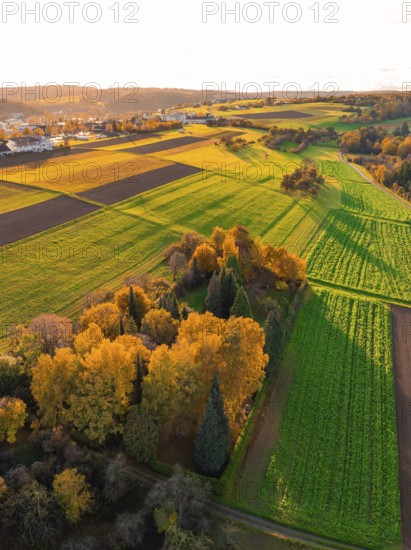 Large-scale autumn landscape with colorful trees and green fields, Aidlingen, Böblingen district, Germany