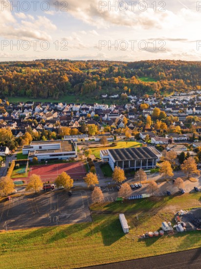 Landscape with village and school surrounded by autumn trees, Aidlingen, Böblingen district, Germany