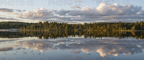 Clouds reflected on the water surface, forest lake, evening mood, panorama, near Sunne, Sweden