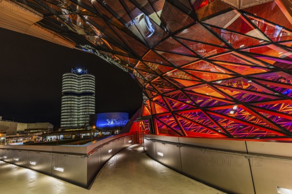 Federally illuminated BMW world, in the back the BMW Museum and the high-rise office building of the BMW headquarters, Petuelring, Munich, Upper Bavaria, Germany