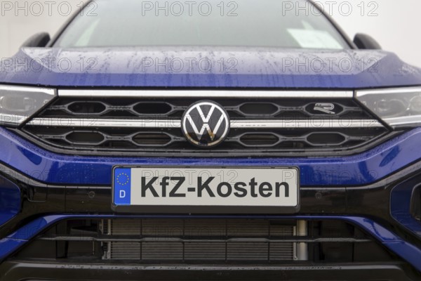(photo montage) Close-up of a license plate with text Car costs