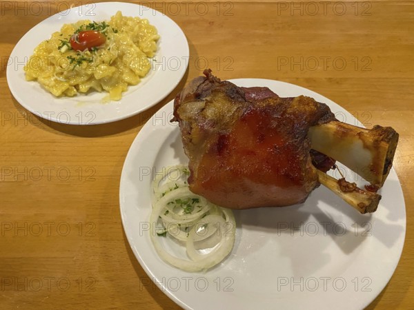 Crispy fried pork knuckle with crust, potato salad, onions, on table, food, Stuttgart, Baden-Württemberg, Germany