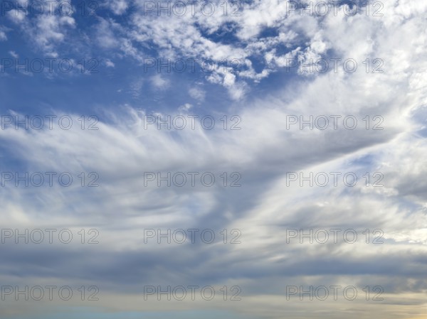 Above white medium-height clouds Altocumulus floccus below Altostratus in front of above blue sky, international