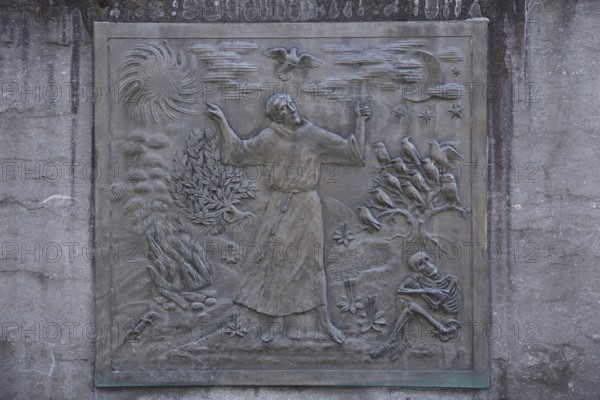 Relief of Saint Francis, Francis of Assisi, monk, monochrome, grey, skeleton, death, bird figures, bird sermon, dove of peace, sky, sun, moon, fire, former Jesuit monastery, Hadamar, Westerwald, Hesse, Germany