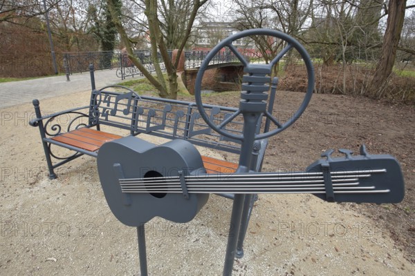 Memorial and sculpture to Elvis Presley with guitar park bench, music notes, microphone, USA bridge, Bad Nauheim, Wetterau, Hesse, Germany