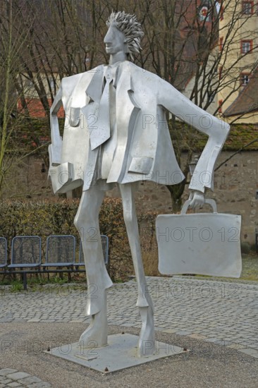 Sculpture man with suitcase by Kurt Laurenz Metzler 2007, sculpture mile, male figure, tin, carrying, hand, hand luggage, suitcase, tie, grey, modern art, An der Riviera, Ansbach, Middle Franconia, Bavaria, Germany