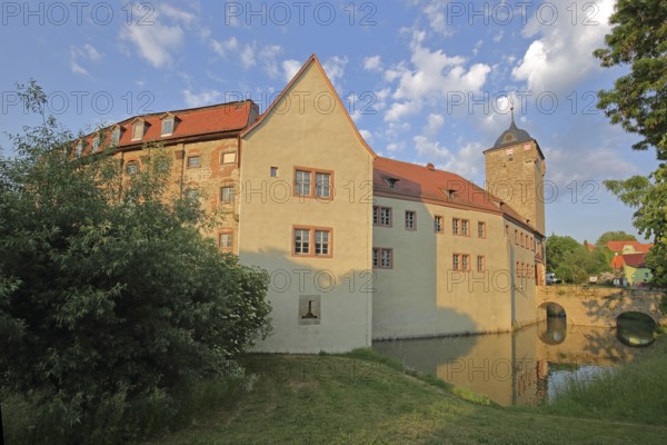 Moated castle built 12th century with tower, arched bridge with pond, medieval Kapellendorf, Thuringia, Germany
