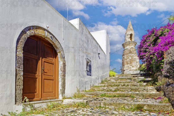Path, paved with steps, northwestern minaret, formerly Bab Gedid Mosque, built in 1585, destroyed by earthquake in 1933, relic, door, house, white, bougainvillea, pink, old town, city of Kos, Dodecanese islands, eastern Aegean Sea, Greece