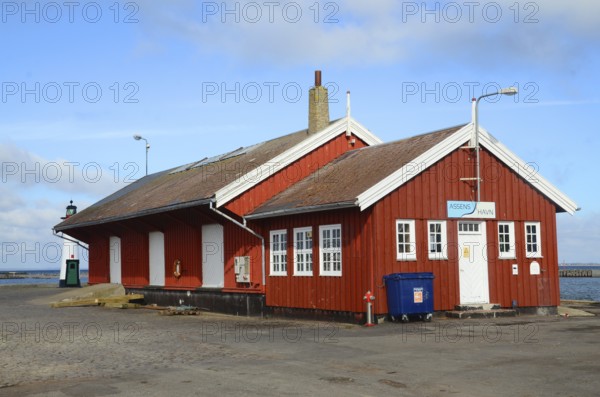 Red wooden house containing customs office in the harbor of Assens, Funen island, Denmark, Scandinavia