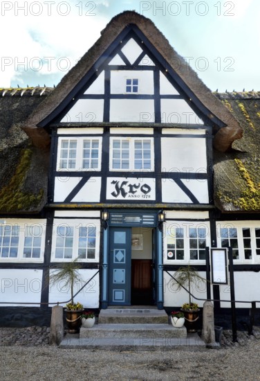 Danish inn, restaurant, in typical half-timbered house with thatched roof on Funen, Fyn island, Denmark, Scandinavia