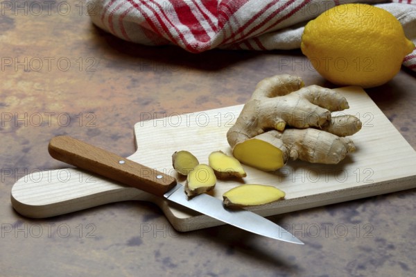 Ginger, ginger root cut with ginger slices on wooden boards