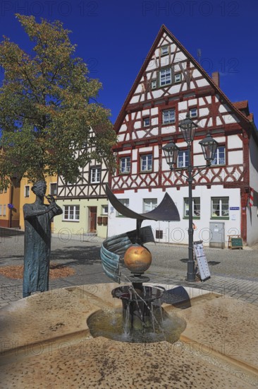 Half-timbered houses and fountain figure flute player, on Rathausplatz, city of Heideck in the district of Roth, Middle Franconia, Bavaria, Germany