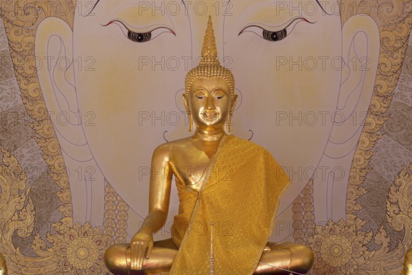 Golden Buddha statue with tunic, Bhumispara mudra, Buddha Gautama at the moment of enlightenment, art hall with exhibition of non-traditional works of art, most of which follow modern art trends such as minimalism and abstraction, Wat Sitthawararam, Bangkok, Thailand