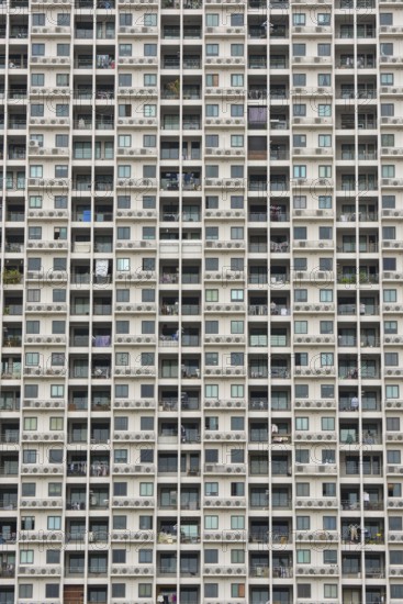 Exterior façade of a residential high-rise building of Condo U (a brand or series name of the Thai real estate developer Grand Unity Development Co., Ltd. (often abbreviated Grand U), Bangkok Yai district, the old town of Bangkok, Thailand
