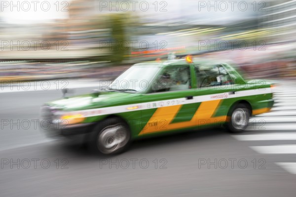Green taxi driving, motion blur, long exposure, Shubuya Crossing, Shibuya, Tokyo, Japan