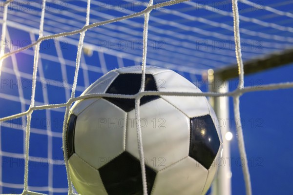 Soccer symbol: close-up of a soccer ball under floodlights
