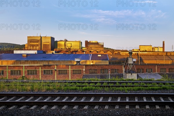 Deutsche Edelstahlwerke with train tracks at sunrise, central railway station, Witten, Ruhr region, North Rhine-Westphalia, Germany