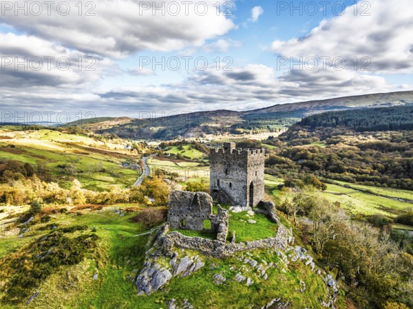 Autumn colours over Castell Dolwyddelan and Eryri Mountains from a drone, Snowdonia, Conwy County Borough, Wales, England, United Kingdom