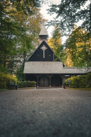 Wooden church in the forest, surrounded by trees in an atmospheric evening atmosphere, Altensteig, Calw district, Germany