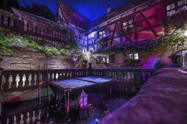 Historic inn, around 1623 with courtyard and fish pond in the evening, Rockenbrunn, Mittelfranklen, Bavaria, Germany