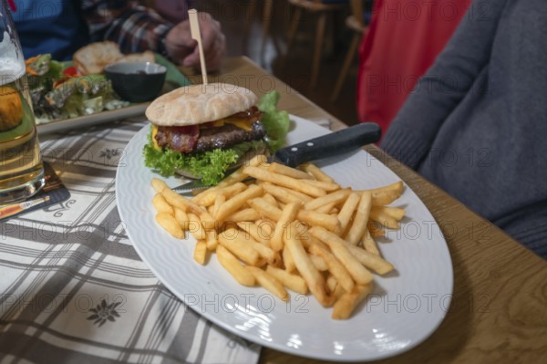 Burger, minced meat with grilled ham and French fries served in an inn, Franconia, Bavaria, Germany