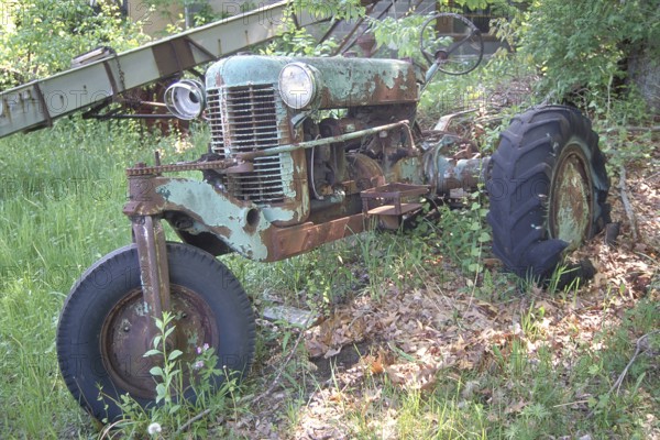 Rusted American Silver King tractor around 1930, dumped in a wooded area, Marksboro, New Jersey, USA