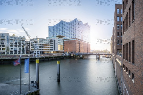 Long exposure of the Elbe Philharmonic Hall with Sandtorhafen and Mahatma Gandhi Bridge in light backlight, Hamburg, Germany