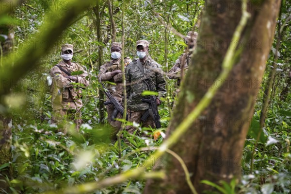 Soldiers, rangers in the jungle, guarding chimpases in the jungle, animal welfare, Kibale National Park, Uganda