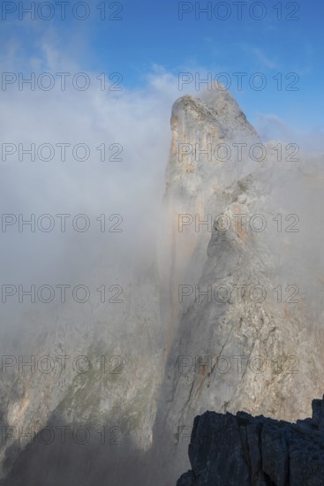 Summit of Wildalmkirchl with steeply sloping rock face surrounded by clouds, Steinernes Meer, Berchtesgaden Alps, Austria
