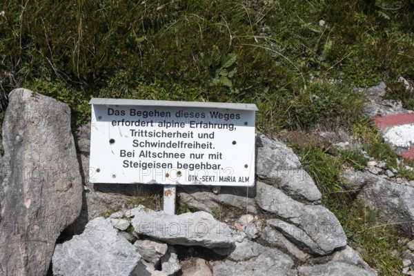 Warning sign with reference to alpine experience, sure-footedness, head for heights, old snow and crampons, on the way to Wasserfallscharte, Steinernes Meer, Berchtesgaden Alps, Austria