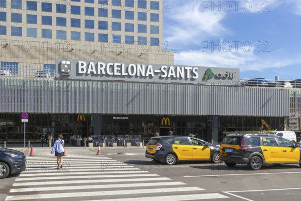 Taxis in street outside Barcelona-Sants railway station building in city centre, Barcelona, Catalonia, Spain
