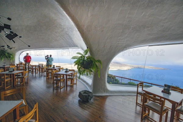 Interior of café with panoramic window in building designed by Cesar Manrique with the collaboration of Jesús Soto and architect Eduardo Caceres without right angles corners on viewpoint tourist attraction El Mirador del Río on the summit of the 474 meter high Risco de Famara in Famaramassiv with panoramic view of the Chinijo Archipelago, La Graciosa island, Lanzarote, Canary Islands, Canary Islands, Spain
