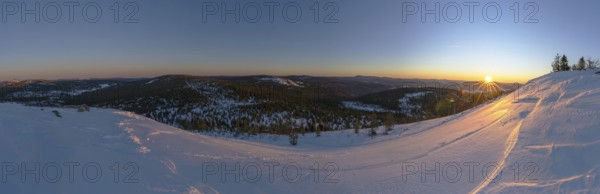 View from Mount Lusen over the hills of the bavarian forest at sunrise in winter, Bavaria, Germany