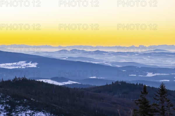 View from Mount Lusen over the hills of the bavarian forest at sunrise in winter, Bavaria, Germany