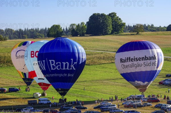 Hot air balloons are being prepared for takeoff as part of an air show at the Fliegerbergfest of the Rossfeld Luftsportverein in Metzingen-Glems, Baden-Württemberg, Germany, for editorial use only