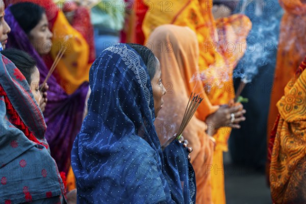 Hindu devotees gather on the banks of the Brahmaputra River to offer prayers to the Sun God on the occasion of Chhath Puja, in Guwahati, India on 27 October 2025