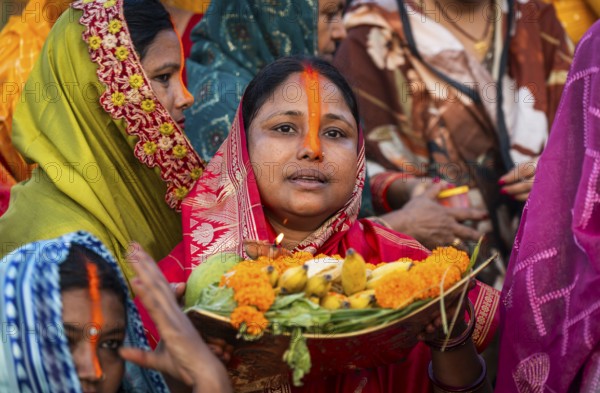 Hindu devotees offer prayers to the Sun God on the bank of Brahmaputra river on the occasion of Chhath Puja, in Guwahati, India on 27 October 2025