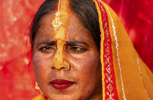 A Hindu devotee offer prayers to the Sun God on the bank of Brahmaputra river on the occasion of Chhath Puja, in Guwahati, India on 27 October 2025
