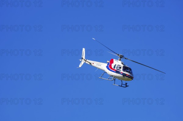 An Aerospatiale AS-350 BA Ecureuil helicopter, registration D-HAAN, from Meravo Air Company during a flight demonstration as part of an air show on Rossfeld in Metzingen-Glems, Baden-Württemberg, Germany, for editorial use only