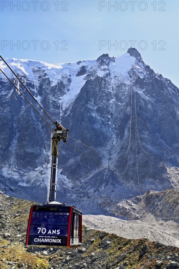 View of the arriving cable car from the Plan de l'Aiguille middle station, in the back the mountain station of the Aiguille du Midi, Chamonix-Mont-Blanc, Haute-Savoie, France