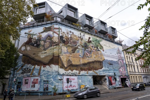The Bilker Bunker, former air raid shelter from 1944, is a listed building, used as a cultural institution since 2023, exhibitions, concerts, events, gastronomy, mural time travelers, on the roof there are 5 cubes with apartments, private property, conversion of civil protection areas, Düsseldorf, North Rhine-Westphalia, Germany