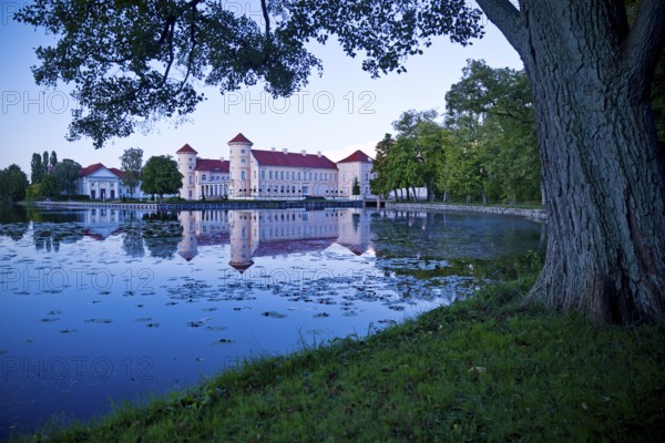 Rheinsberg Castle, lakeside with Lake Grienerick at night, prime example of Friederician Rococo, Brandenburg, Germany