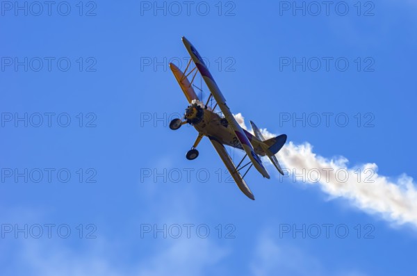 A Boeing PT-17 Stearman biplane, also Boeing Stearman Model 75, with the inscription 399 USNAVY N67193 during a flight demonstration as part of an air show on Rossfeld in Metzingen-Glems, Baden-Württemberg, Germany, for editorial use only