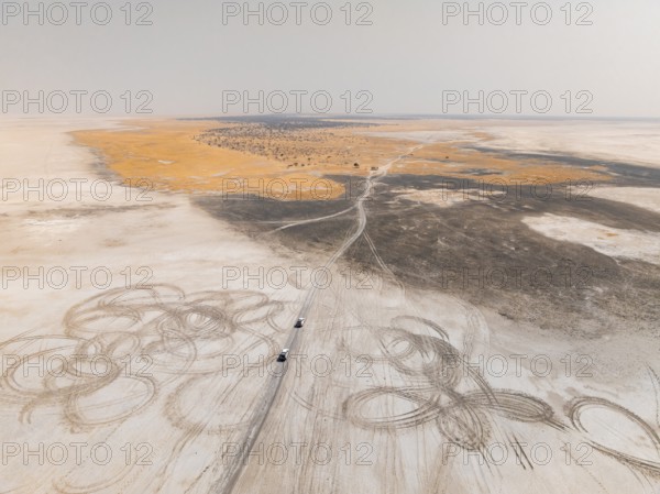 Aerial view, tire tracks on a salt pan, arid landscape, Botswana