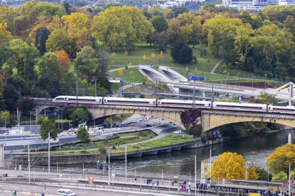 Bridges across the Neckar in Bad Cannstatt with Rosenstein Park. The ICE is still running on the old Rosenstreinbrücke. When the new main train station is completed, the trains will travel across the new Neckar bridge behind it. Stuttgart, Baden-Württemberg, Germany