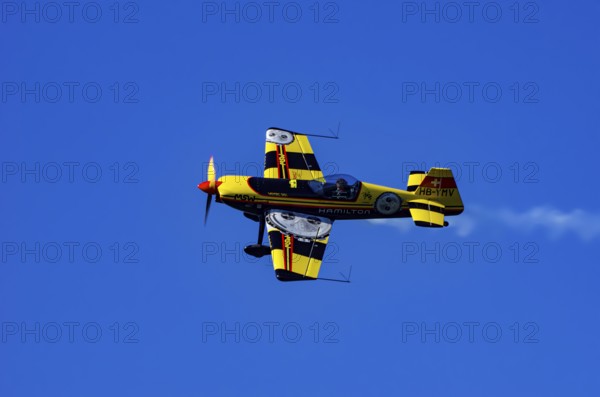 A Votec 351 sport aircraft from the Swiss MSW Aviation AG with registration HB-YMV during a flight demonstration as part of an air show on Rossfeld in Metzingen-Glems, Baden-Württemberg, Germany, for editorial use only