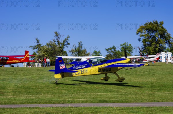 An Extra EA-300 from Extra Flugzeugproduktions- und Vertriebs GmbH with registration D-EXBH during a flight demonstration as part of an air show on Rossfeld in Metzingen-Glems, Baden-Württemberg, Germany, for editorial use only