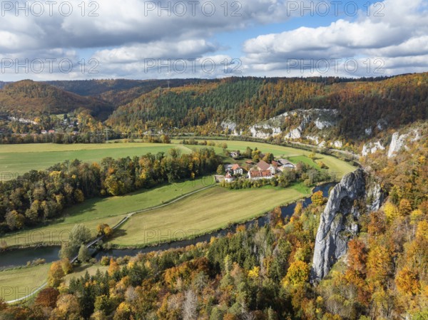 Aerial view of Käppeler Manor with St. George's Basilica near Thiergarten in the Upper Danube Valley, surrounded by autumn vegetation, on the right the raven rocks, climbing rocks, Jura limestone rocks, Sigmaringen district, Baden-Württemberg, Germany